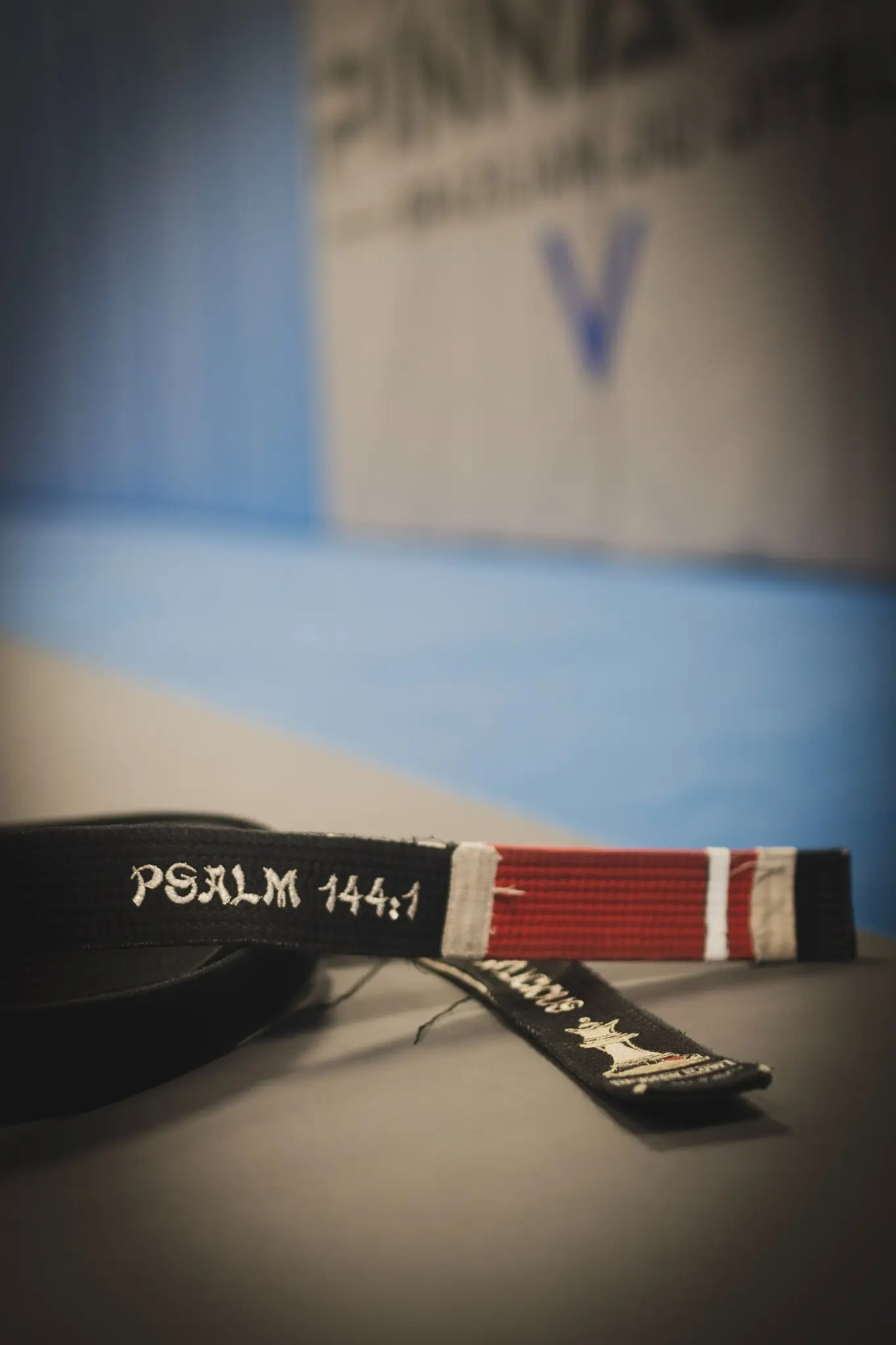 A black belt tied at the waist of a Brazilian Jiu Jitsu gi