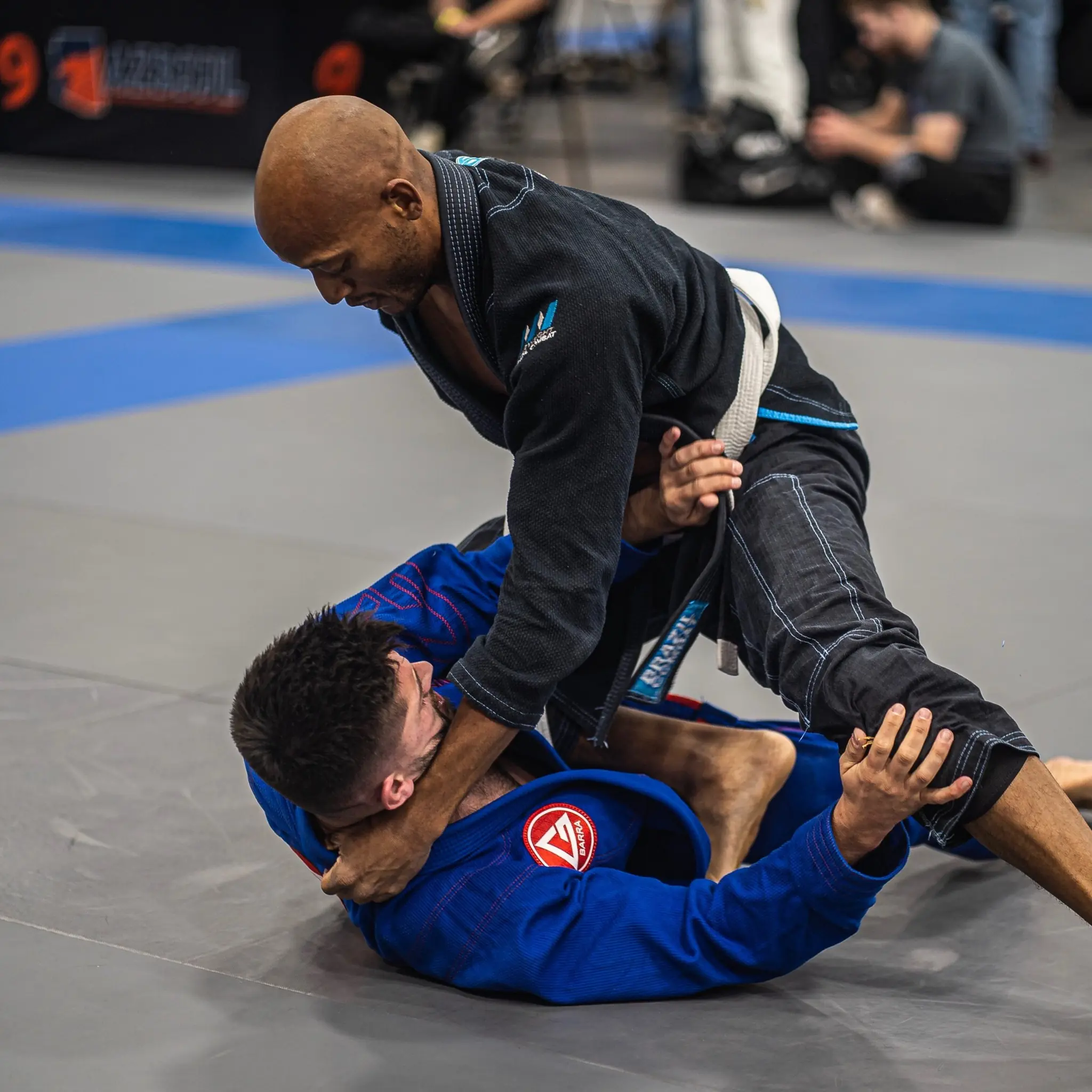 Competitors grappling during a Brazilian Jiu Jitsu tournament